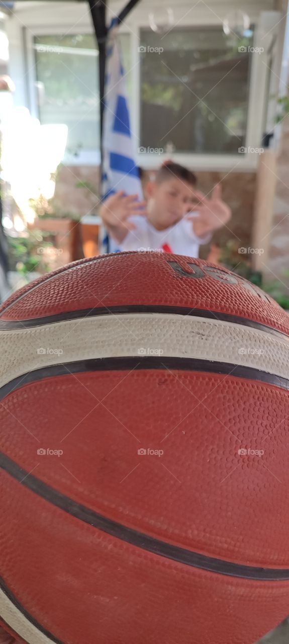 the boy playing basketball