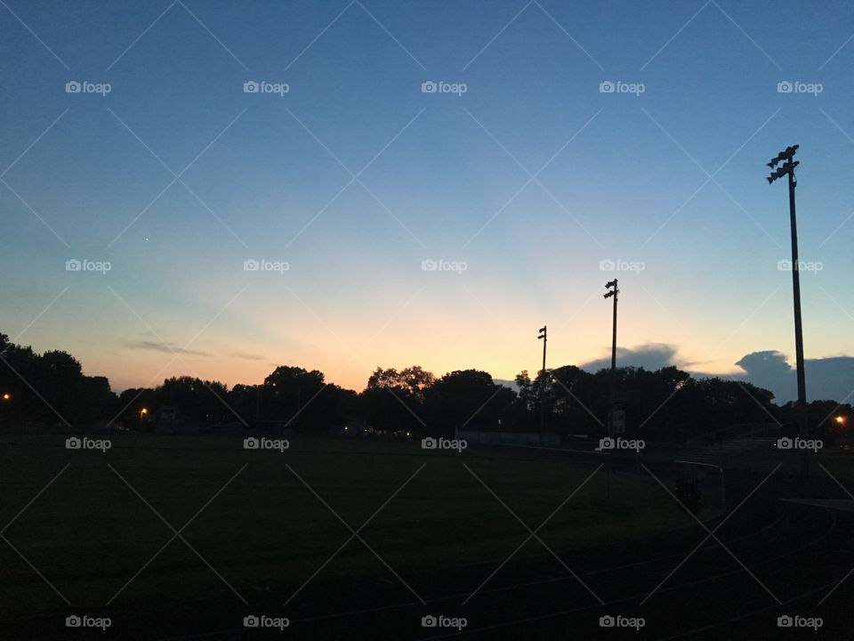 Sunset behind a football field. 