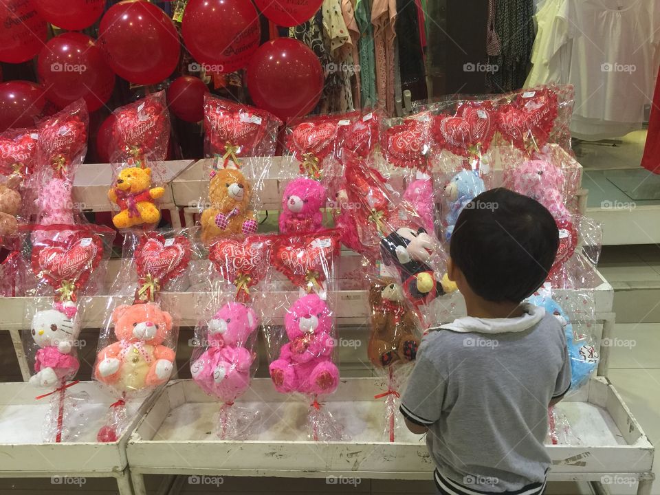 A littleboy holding valentine gift