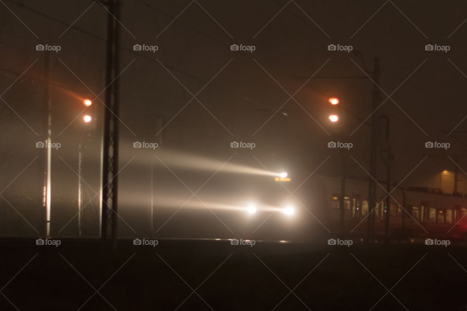 Train head lights in the mist