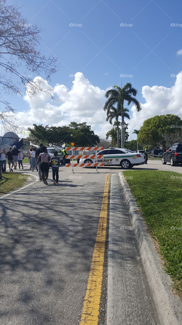 sheriff police car guiding walking fair festival traffic