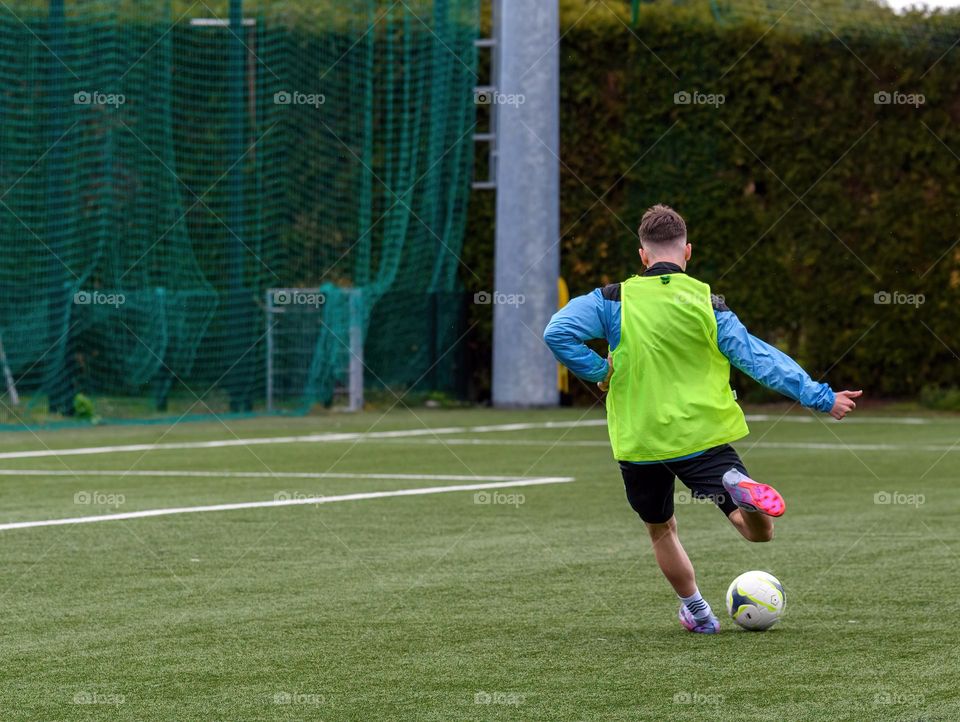 Rear view of young football player during practice
