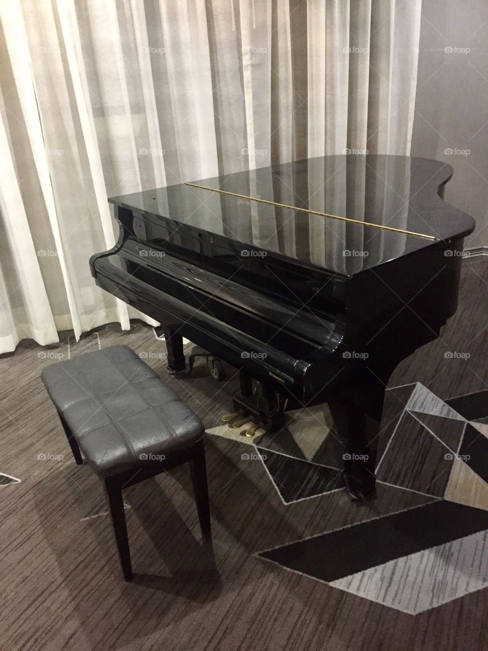 Black piano in a hotel lobby