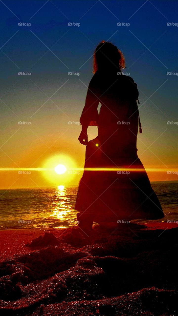 woman on the beach sunset