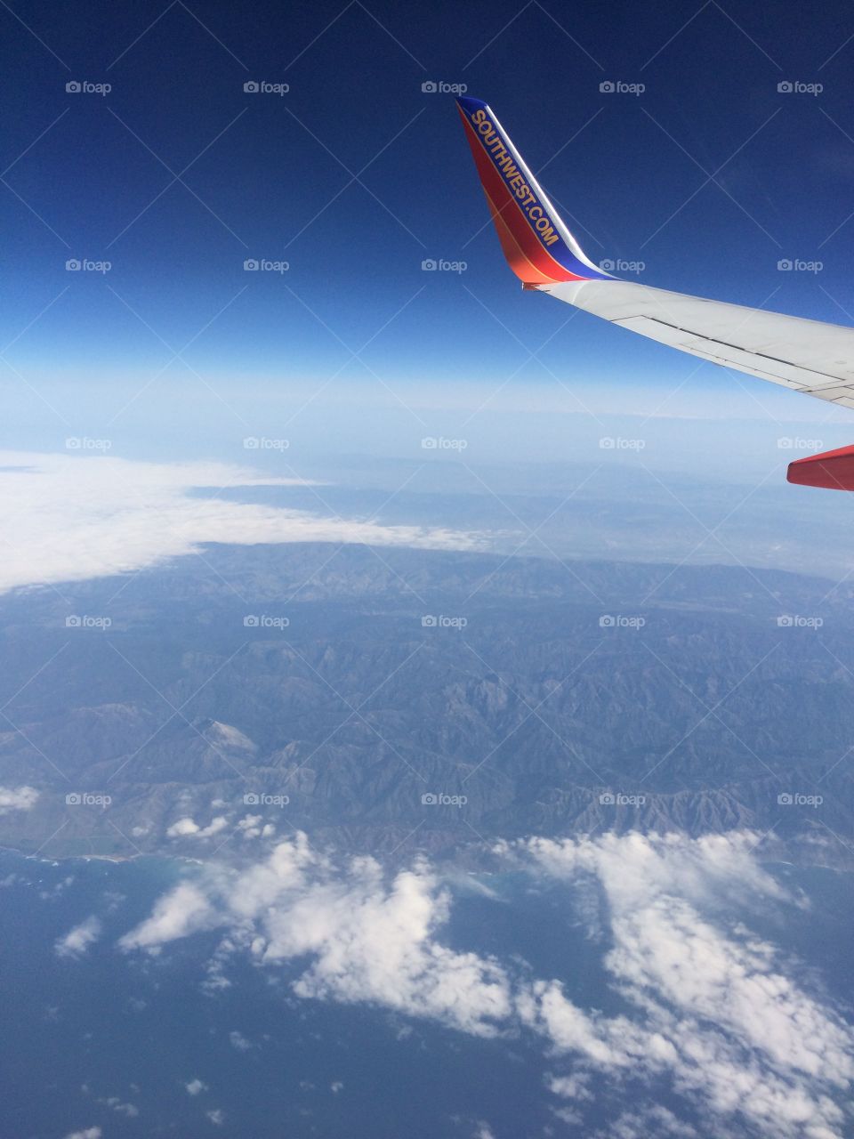 Looking down from an airplane window to see the mountains in California. 
