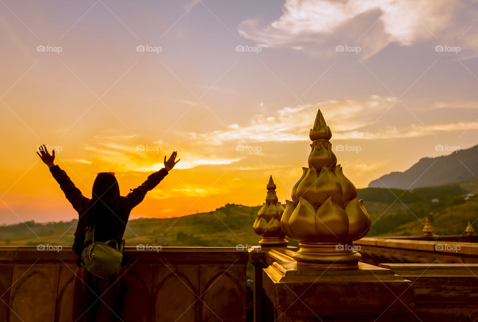 Rear view of man standing at sunset