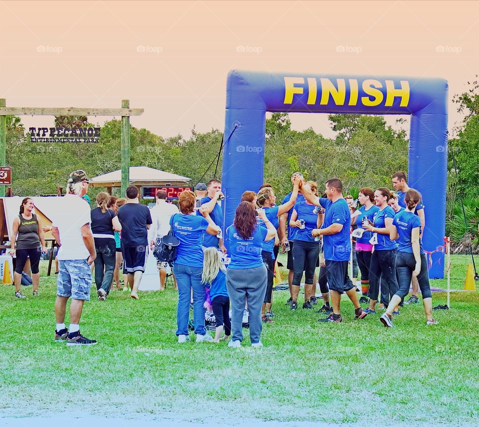 Joggers celebrating the finish of a successful road race.