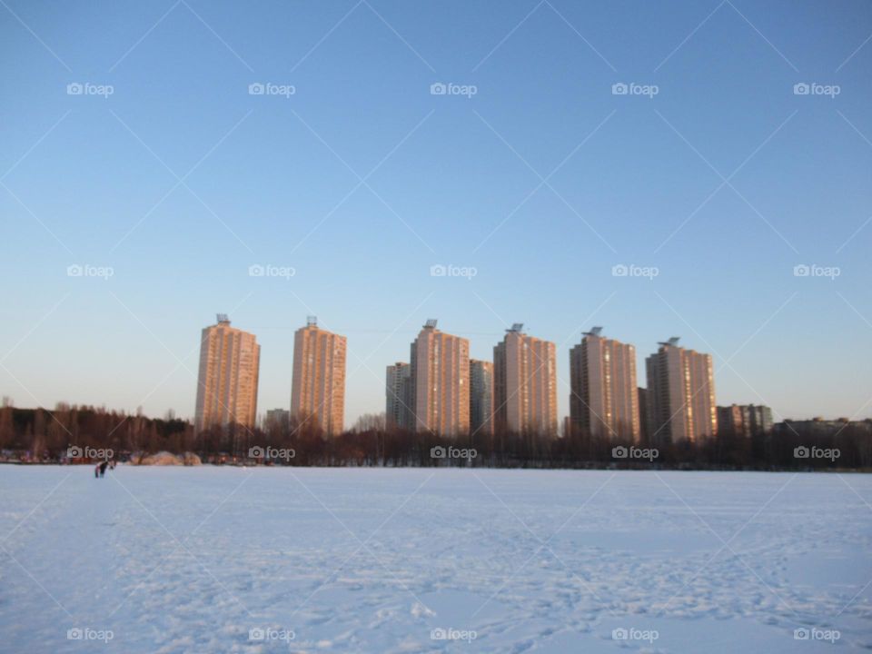 city ​​in the center of Russia Voronezh, winter, residential buildings, a pond under the ice, the first of March, spring has come