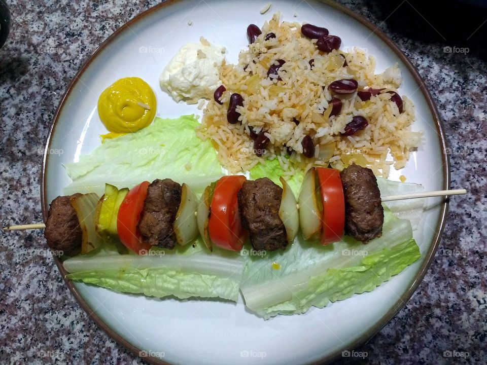 a hamburger dinner made to look like a kebab.