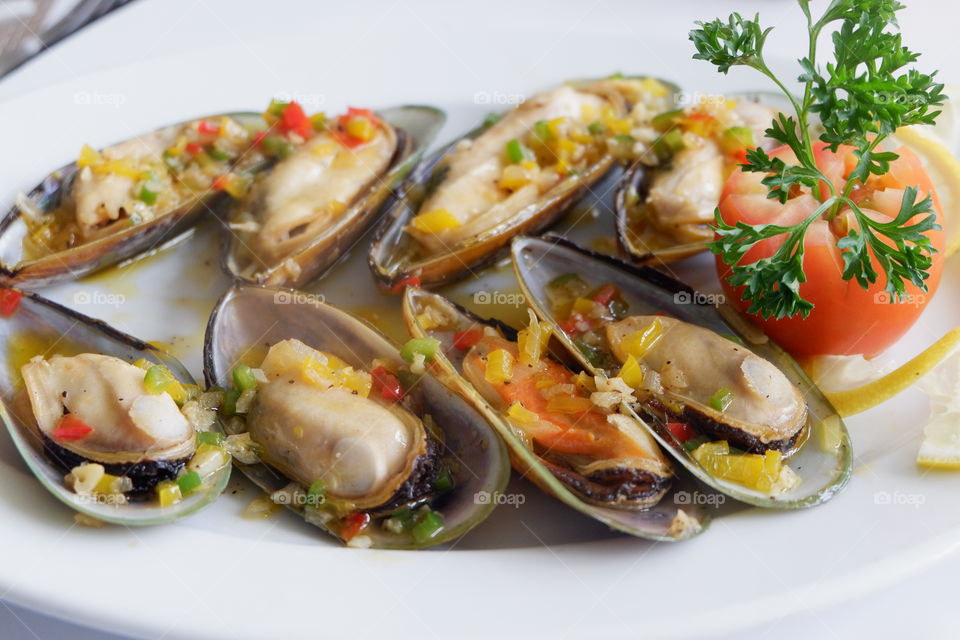 Delicious mussels on white plate