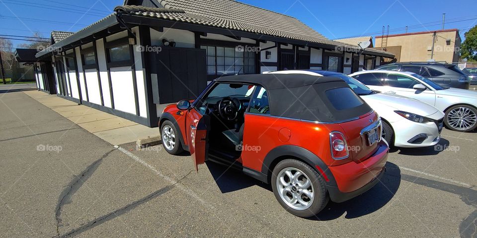 Zip zipping through town to work with my metallic orange 2011 Mini Cooper convertible car. Stroll downtown with a fun car and saves gas. Happy owner!