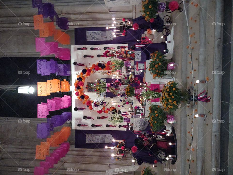 Day of the Dead Altar at Cathedral of St. John the Divine with pink purple and orange papel picado