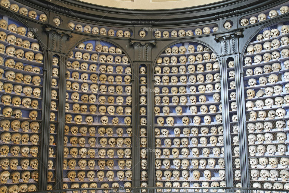 human skulls on shelves in ossuary