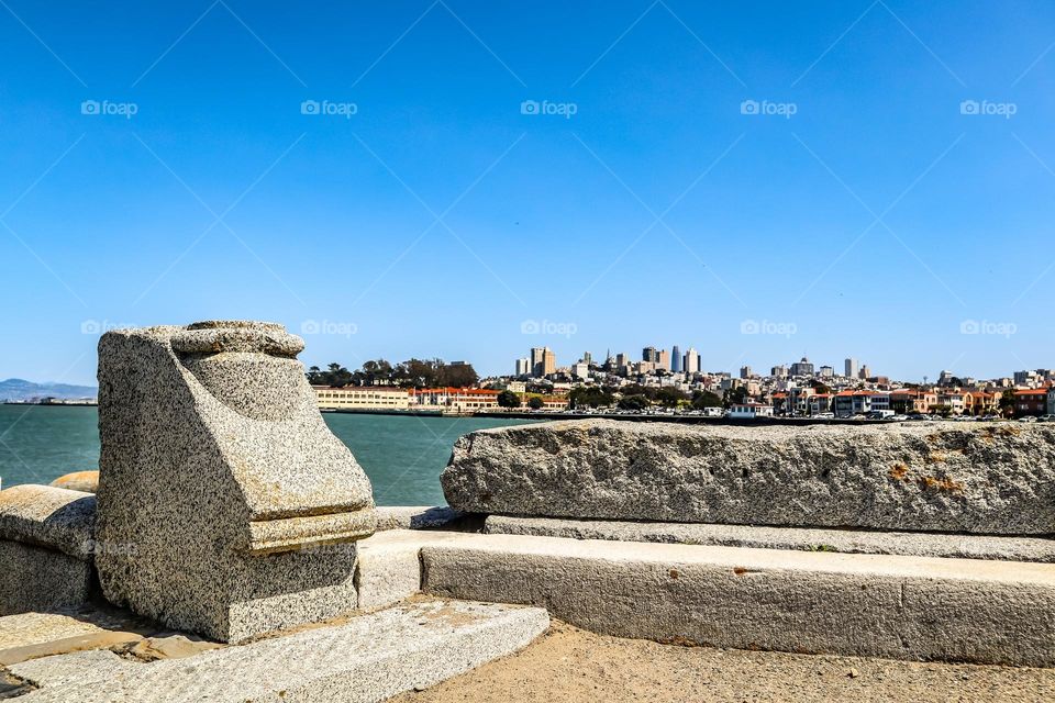 Looking at the San Francisco skyline in California from the wave organ in the San Francisco Bay on a clear spring afternoon with calm blue skies 