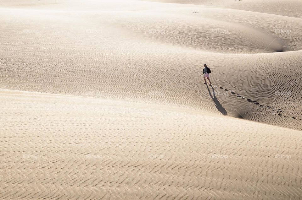 A woman walking in big desert