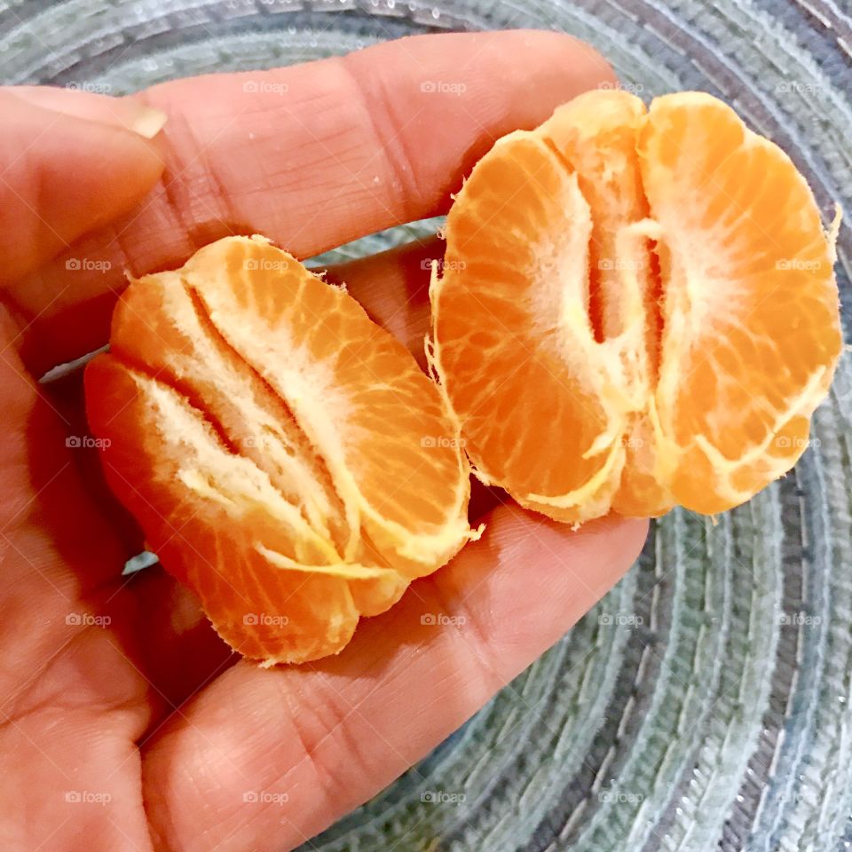 Close-up of peeled orange in Hand