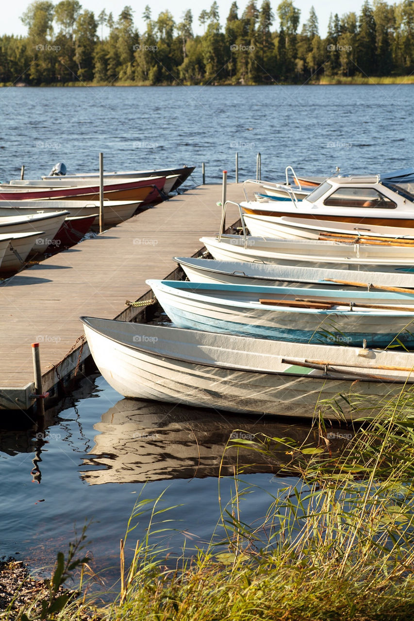 Boats parked in a little lakeside harbor