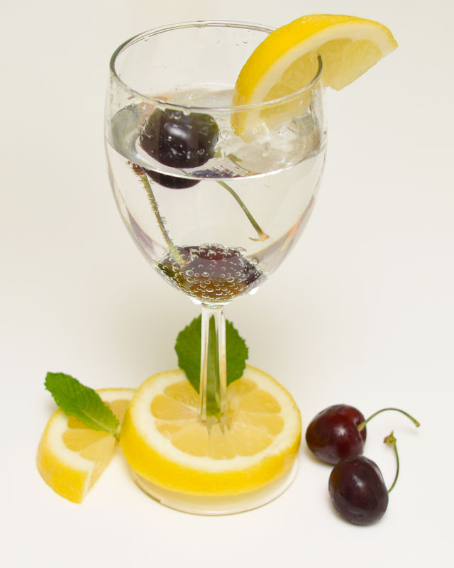 Fruits lemons and cherries in a drink