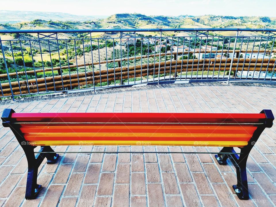 empty rainbow bench and Italian panorama