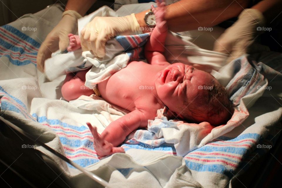 Newborn getting cleaner after birth 