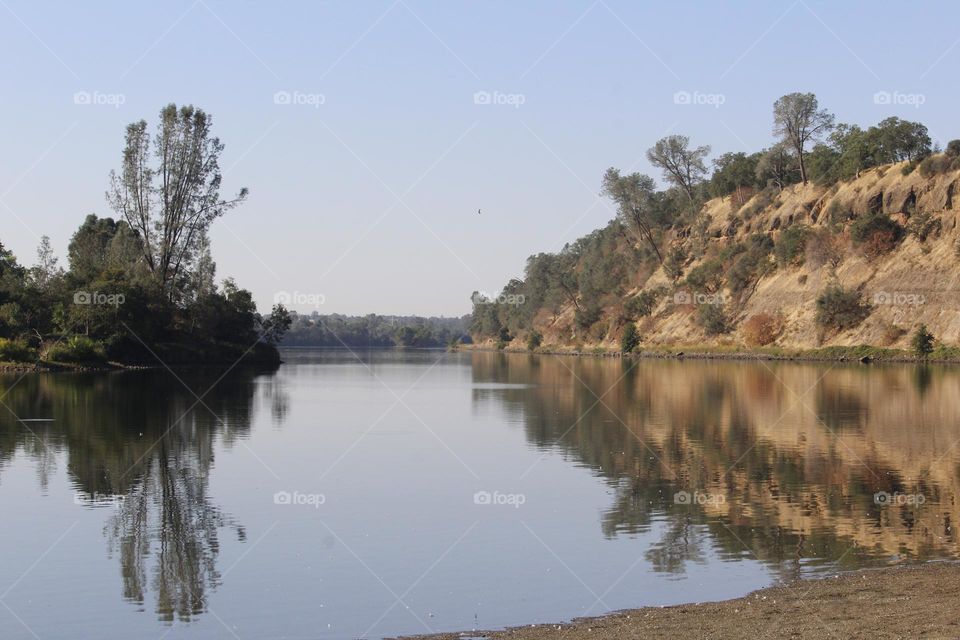 Beach view of a reflective Waterway