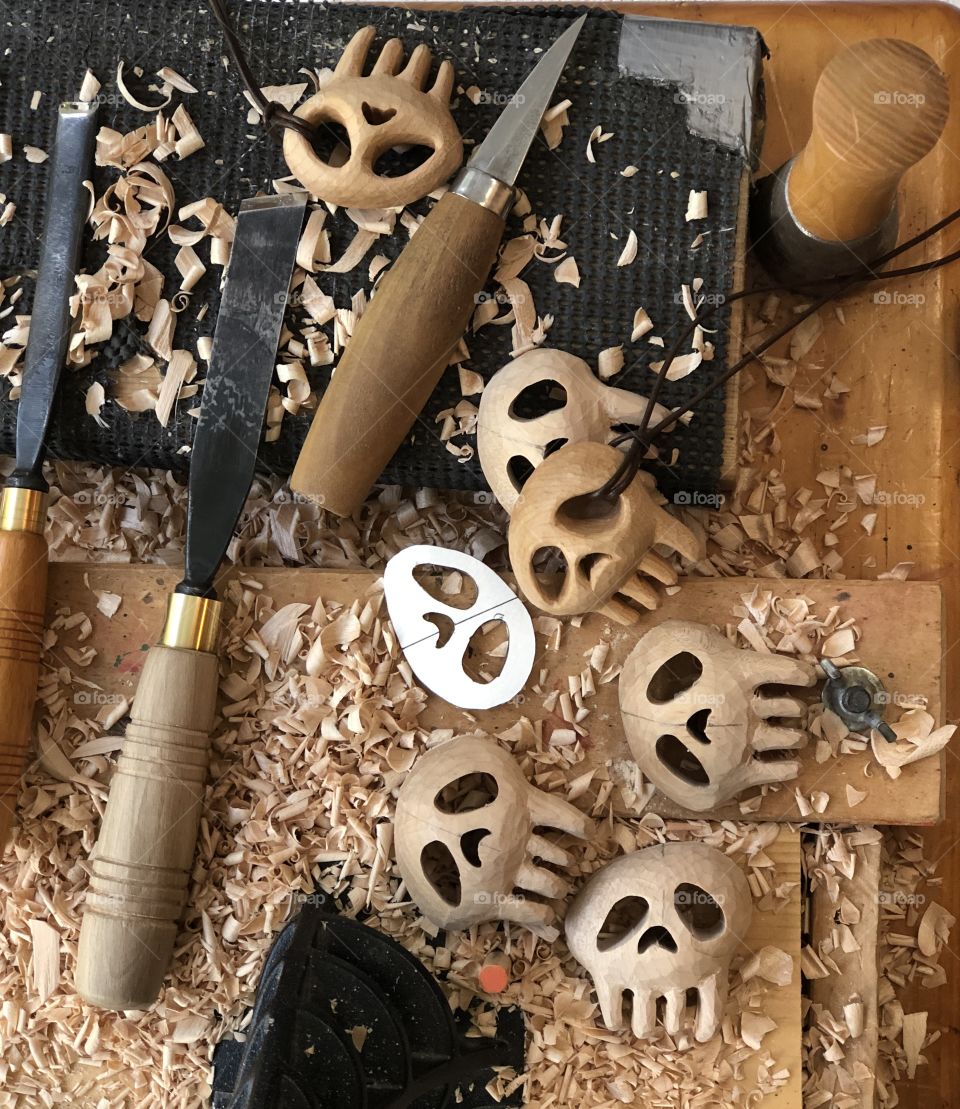 Carving some wooden skull pendants