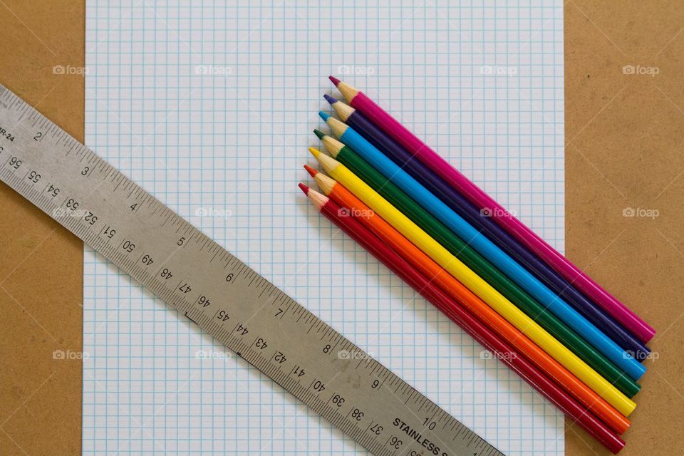 Colored pencils and ruler on graph paper