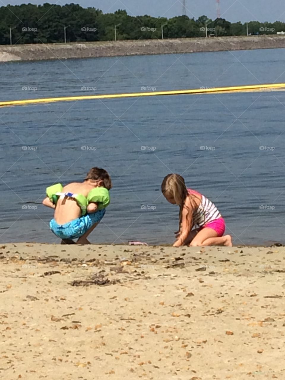Kids playing in the water and sand