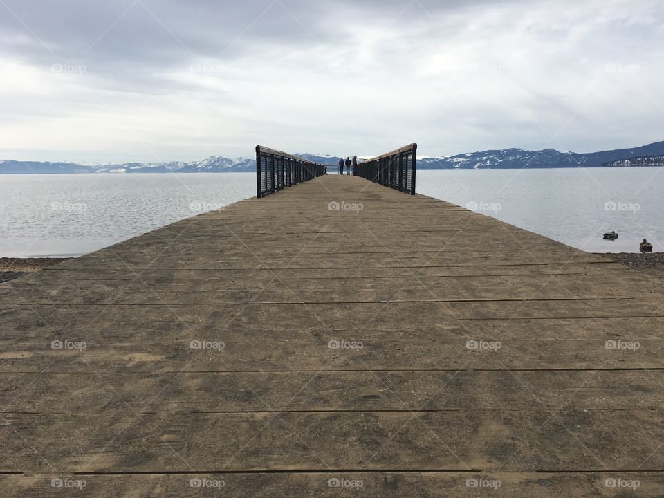 Looking straight down the pier towards landscape