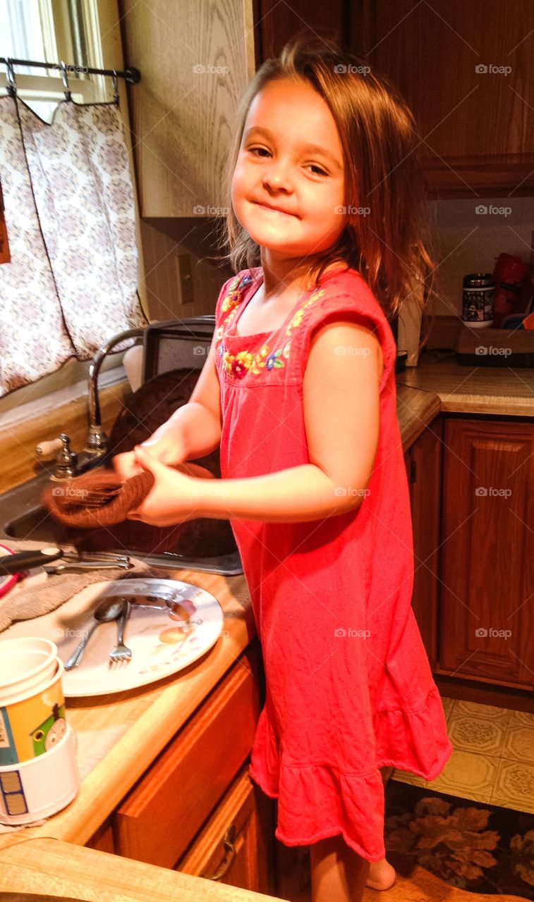 Girl washing plate at home