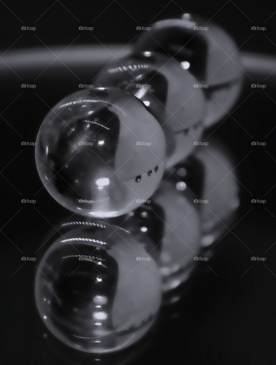 3 marble reflection on a mirrored piece of glass