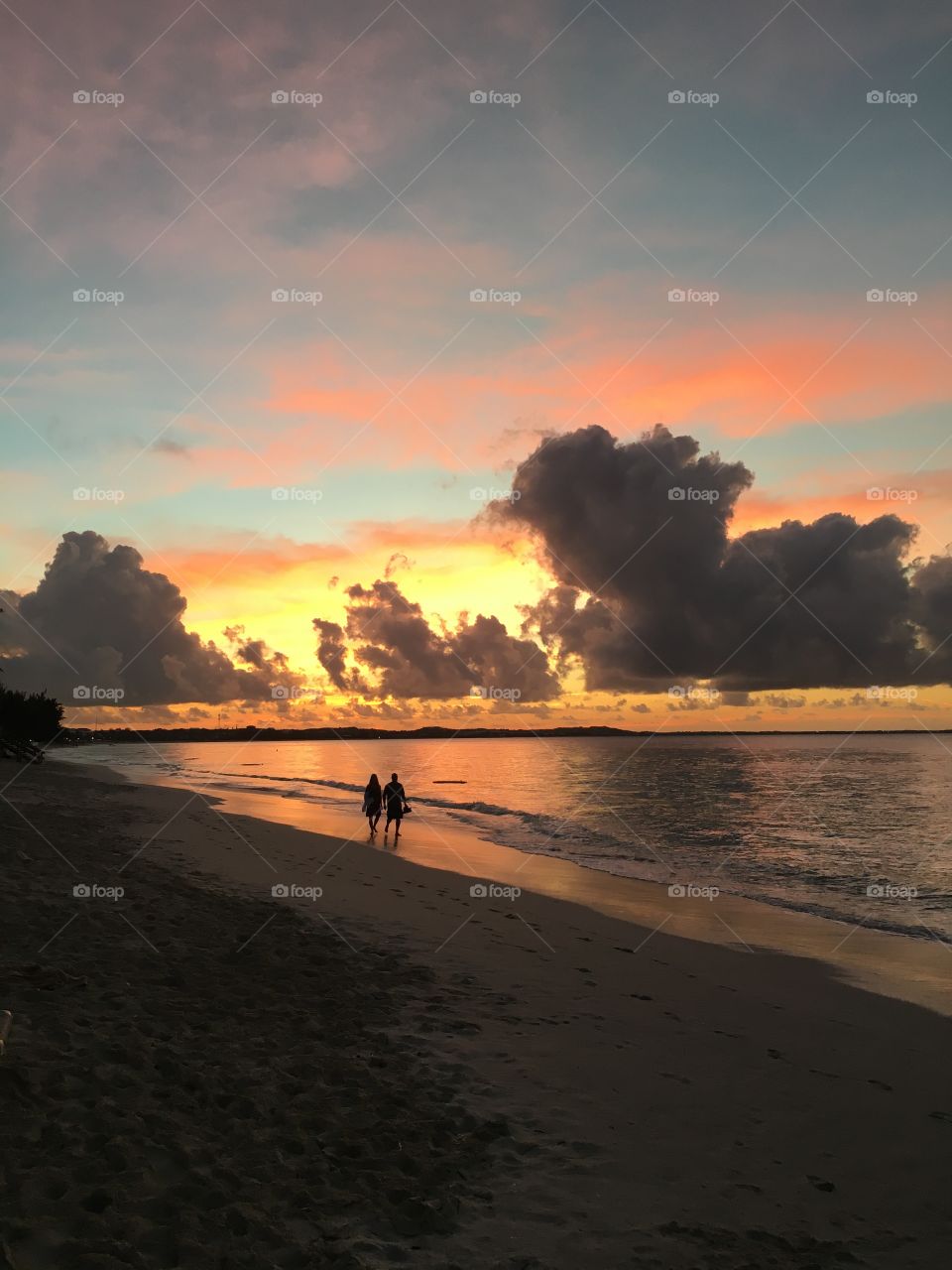 Romantic sunset stroll along the beach. 