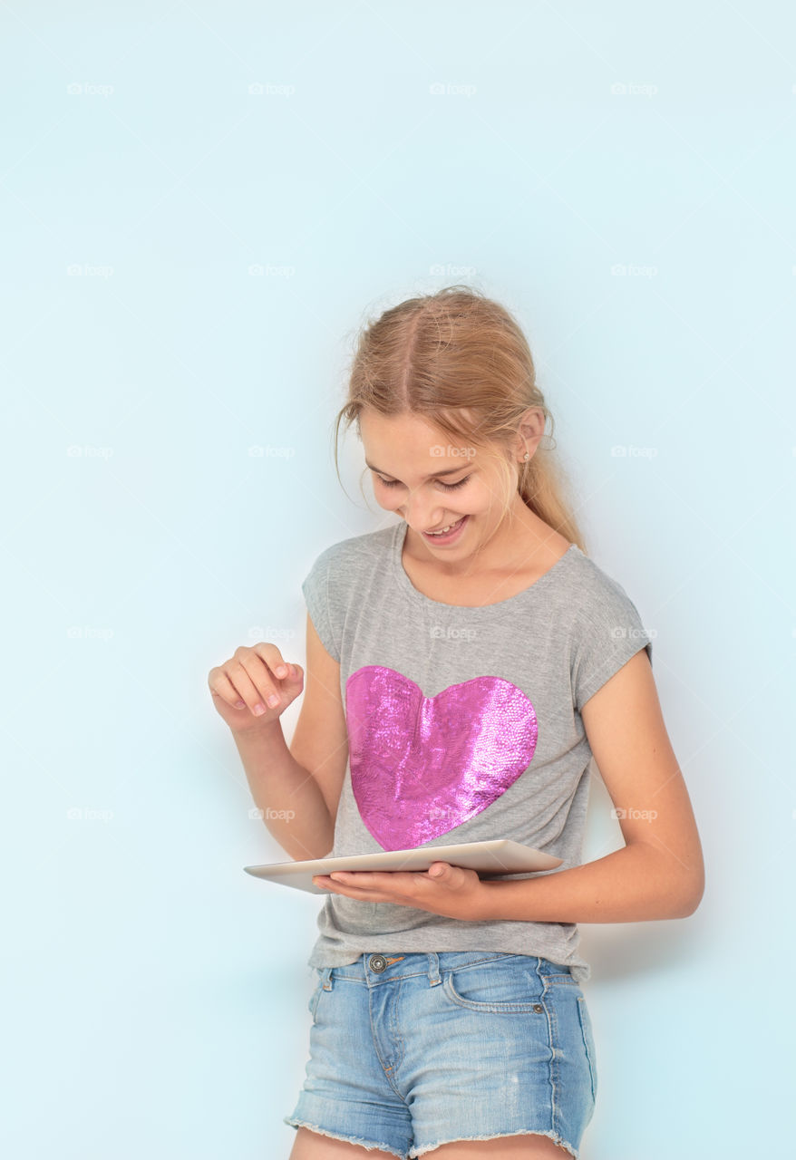 Teenage girl with tablet in hand