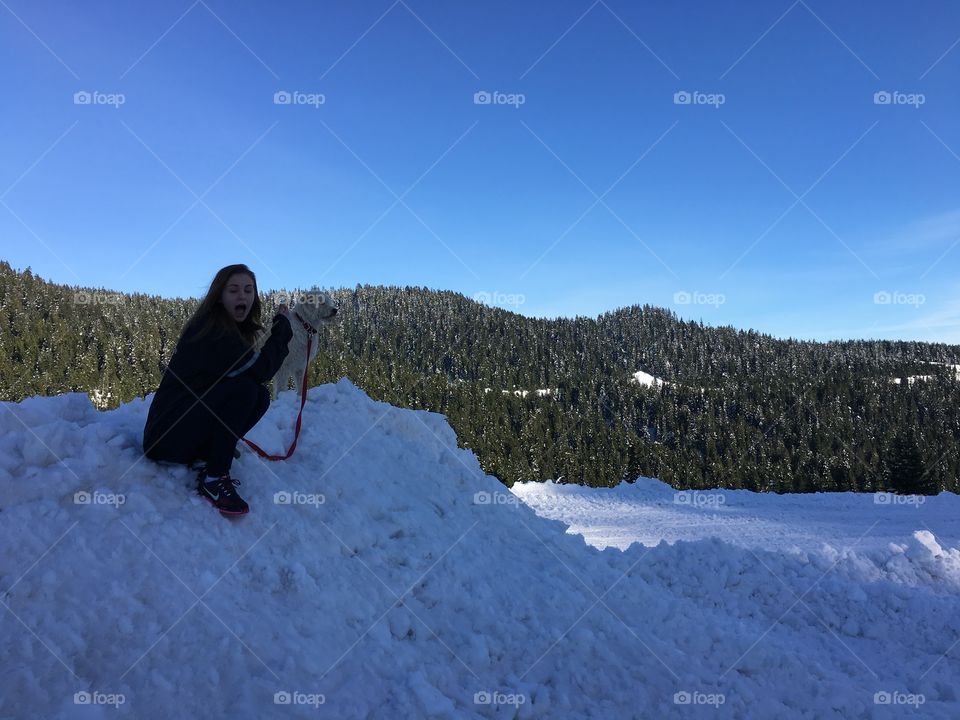 Sitting on snow with her dog