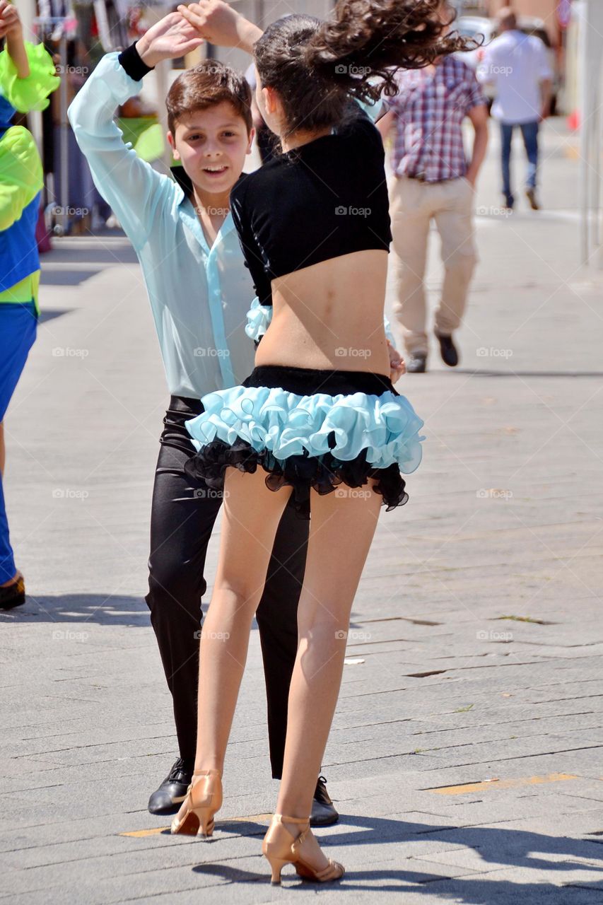 young couple dancing in the street