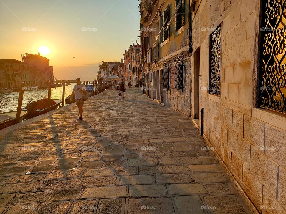 cobblestone walkway in Venice along the water