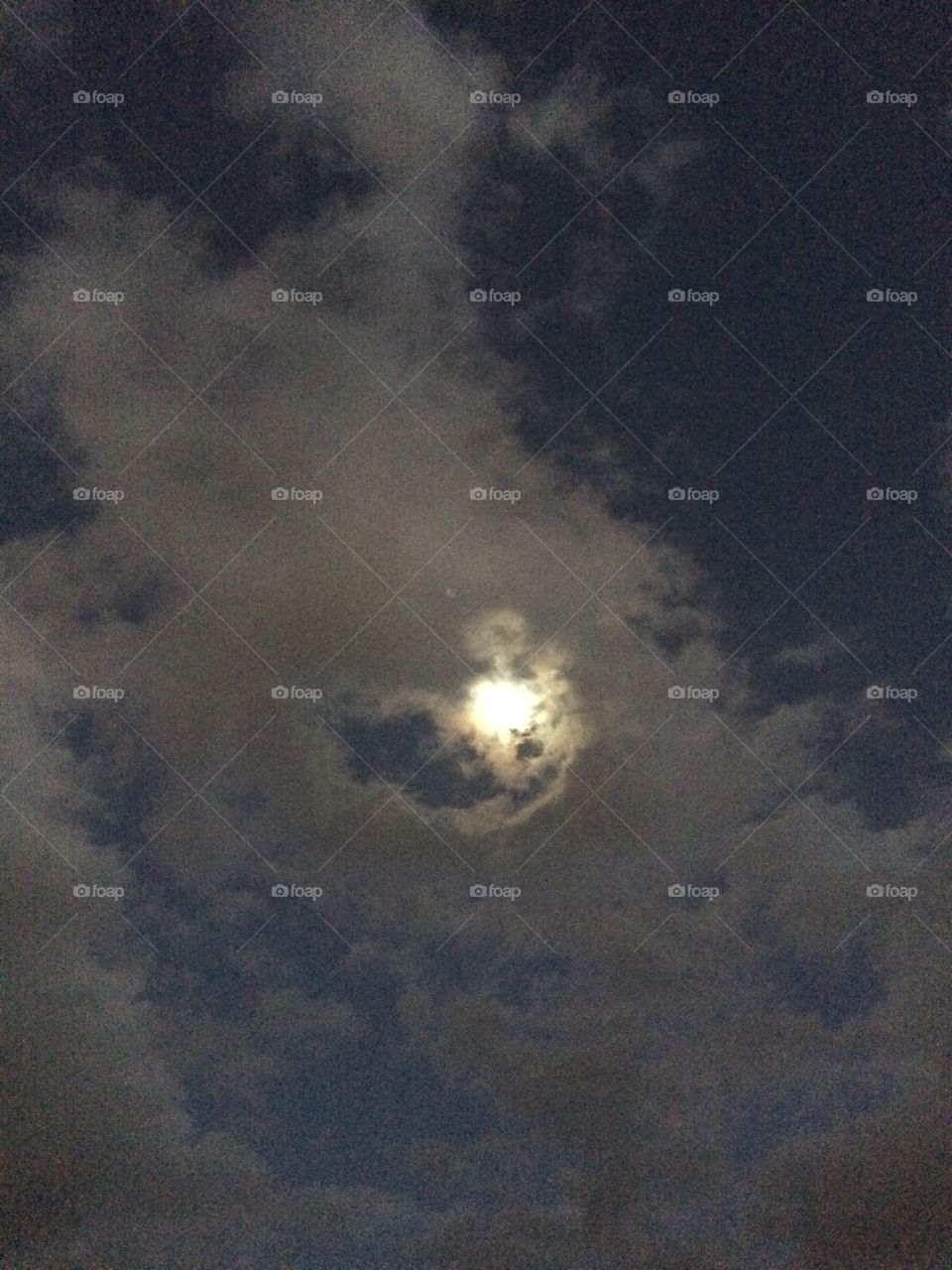 The moon shines through the clouds.