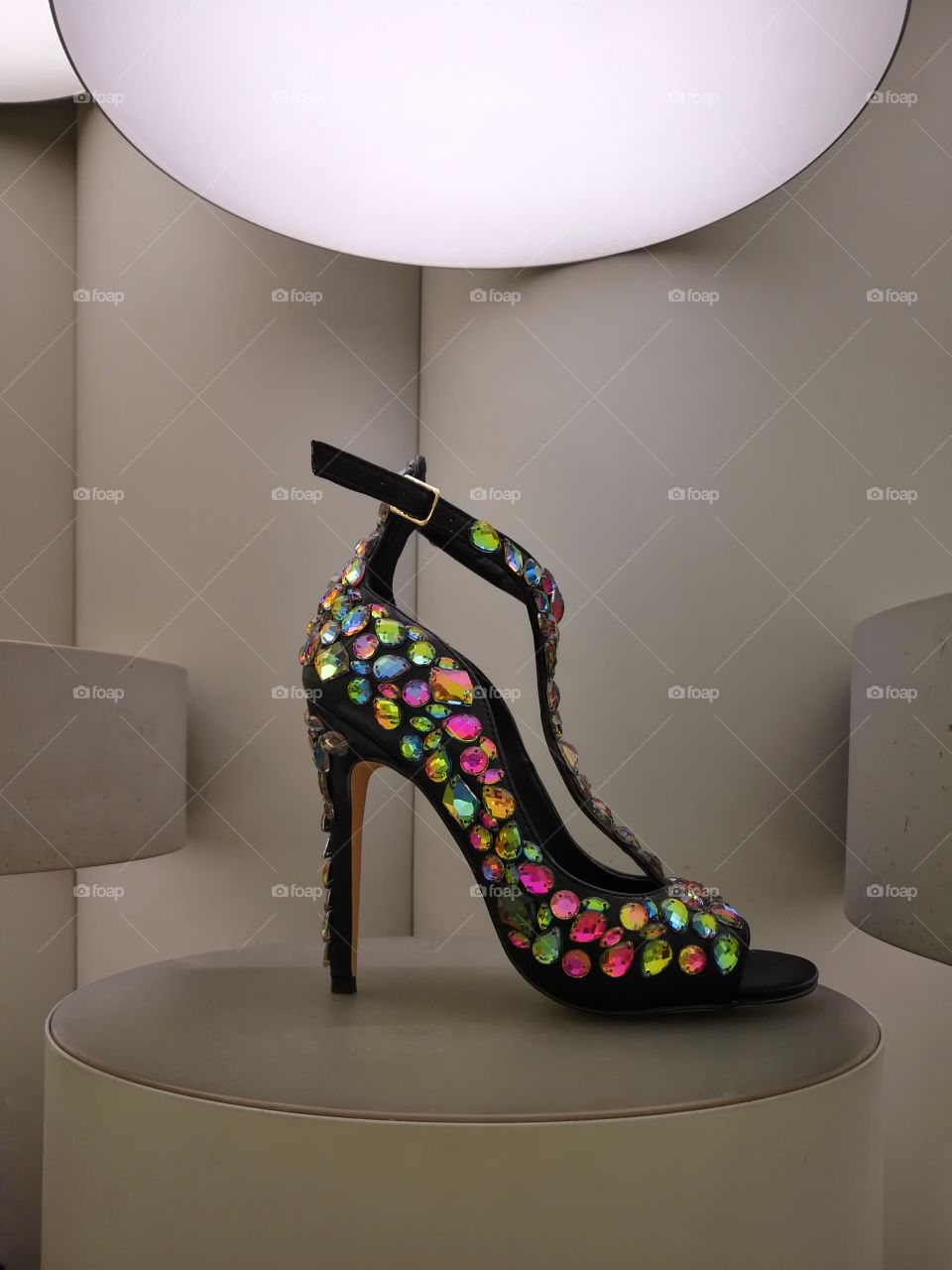 glitter and glamour black high heel with colourful cristals on futuristic display