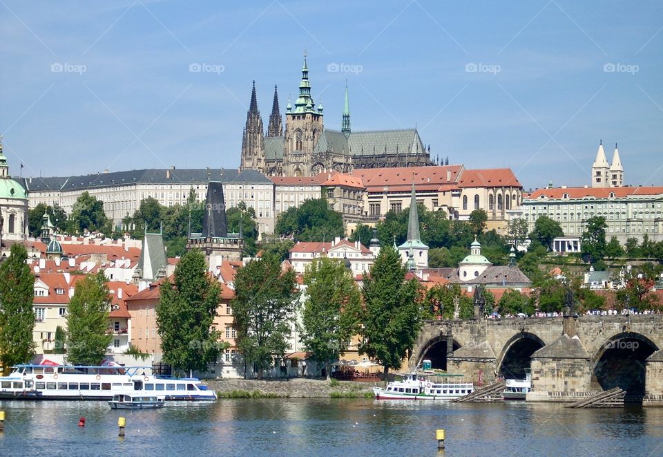 View of Charles Bridge, Prague, Czech Republic, crossing the Vitava River, with the cathedral in the background. 