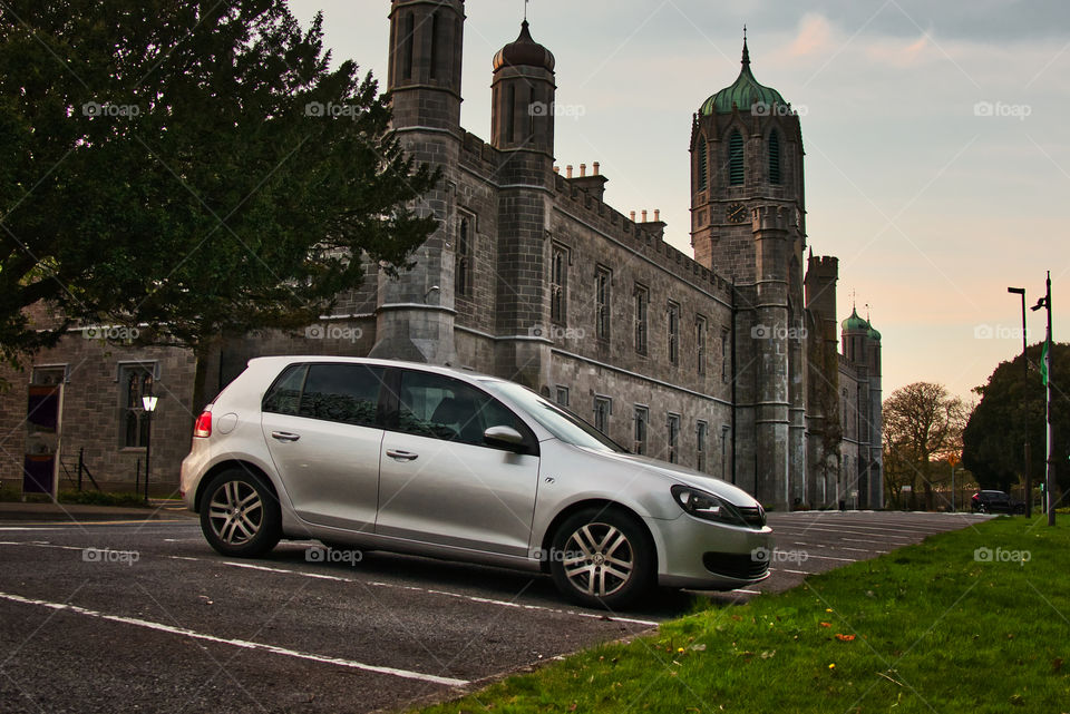 Car Volkswagen golf on a parking in front of castle