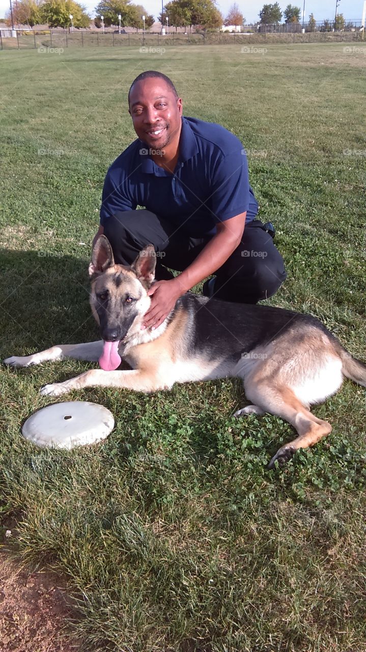 1 guy and his friend. Out at the park playing frisbee with some friends