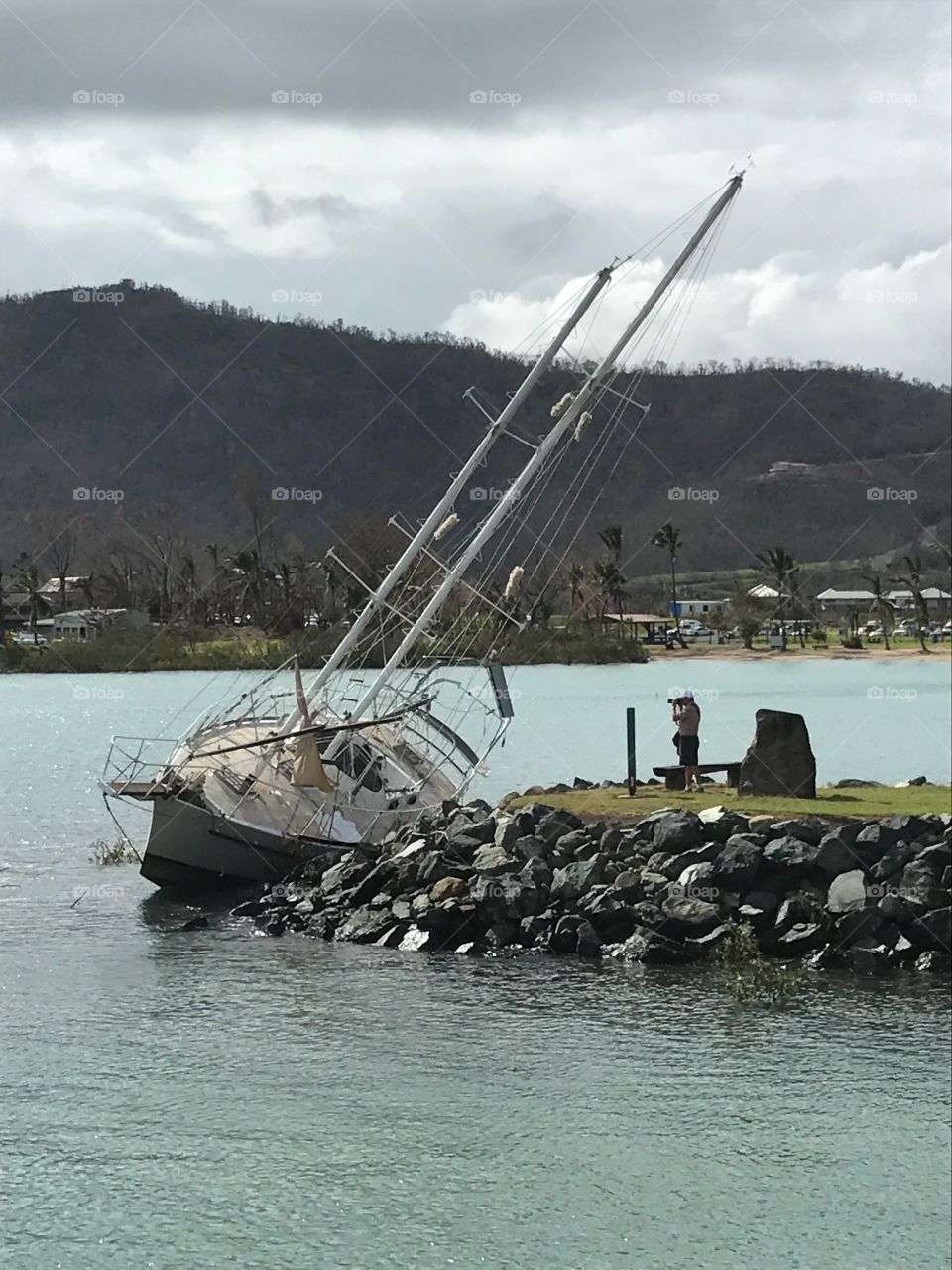 Capsized sailboat in aftermath of Cyclone Debbie in Queensland south Australia 2017