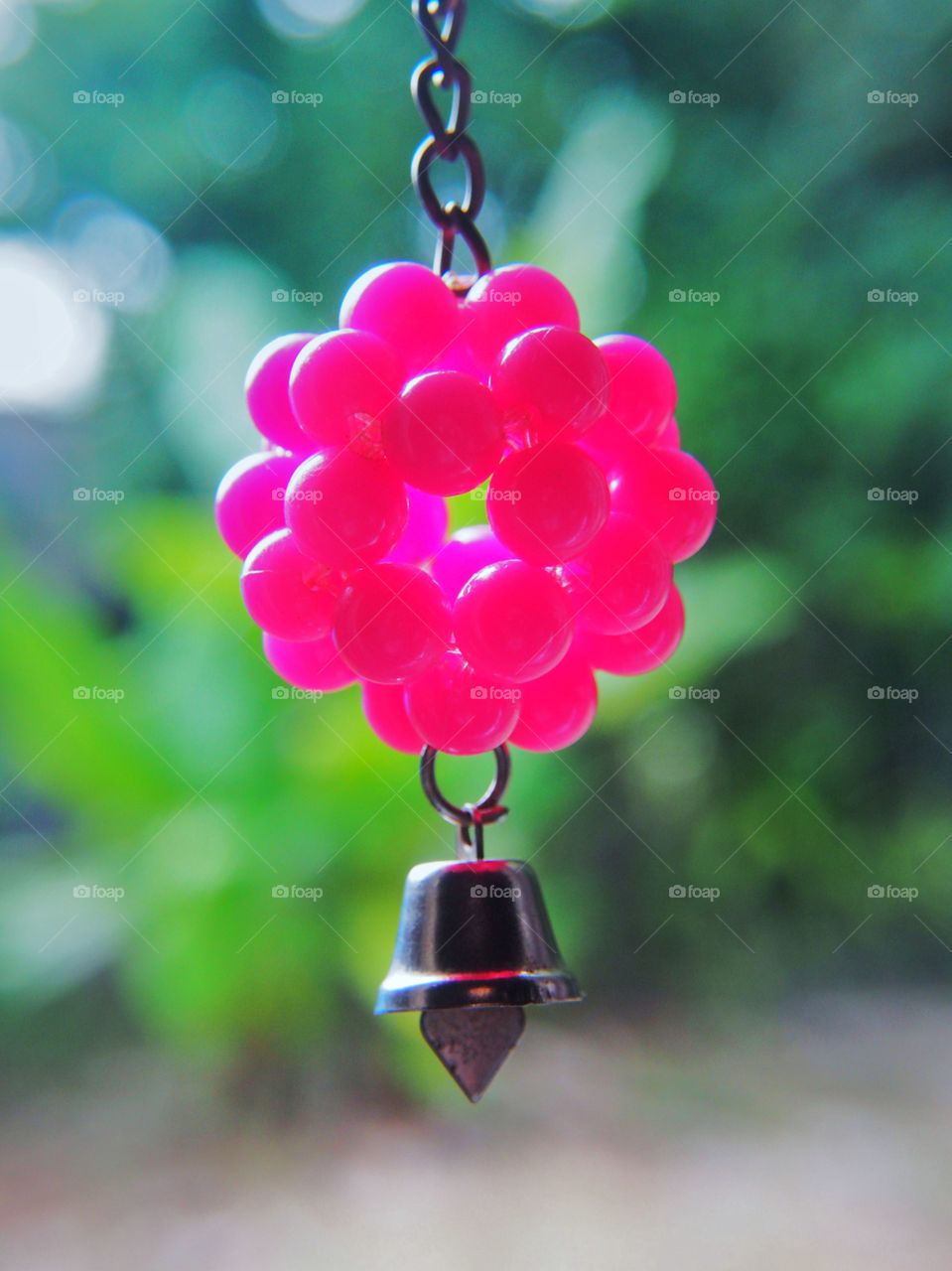 Pink key chain green blur background