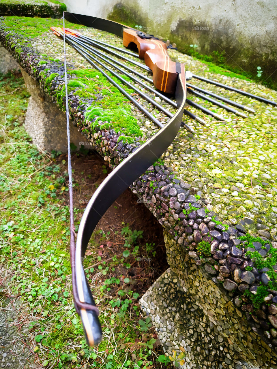 Sports bow and arrow on a stone bench