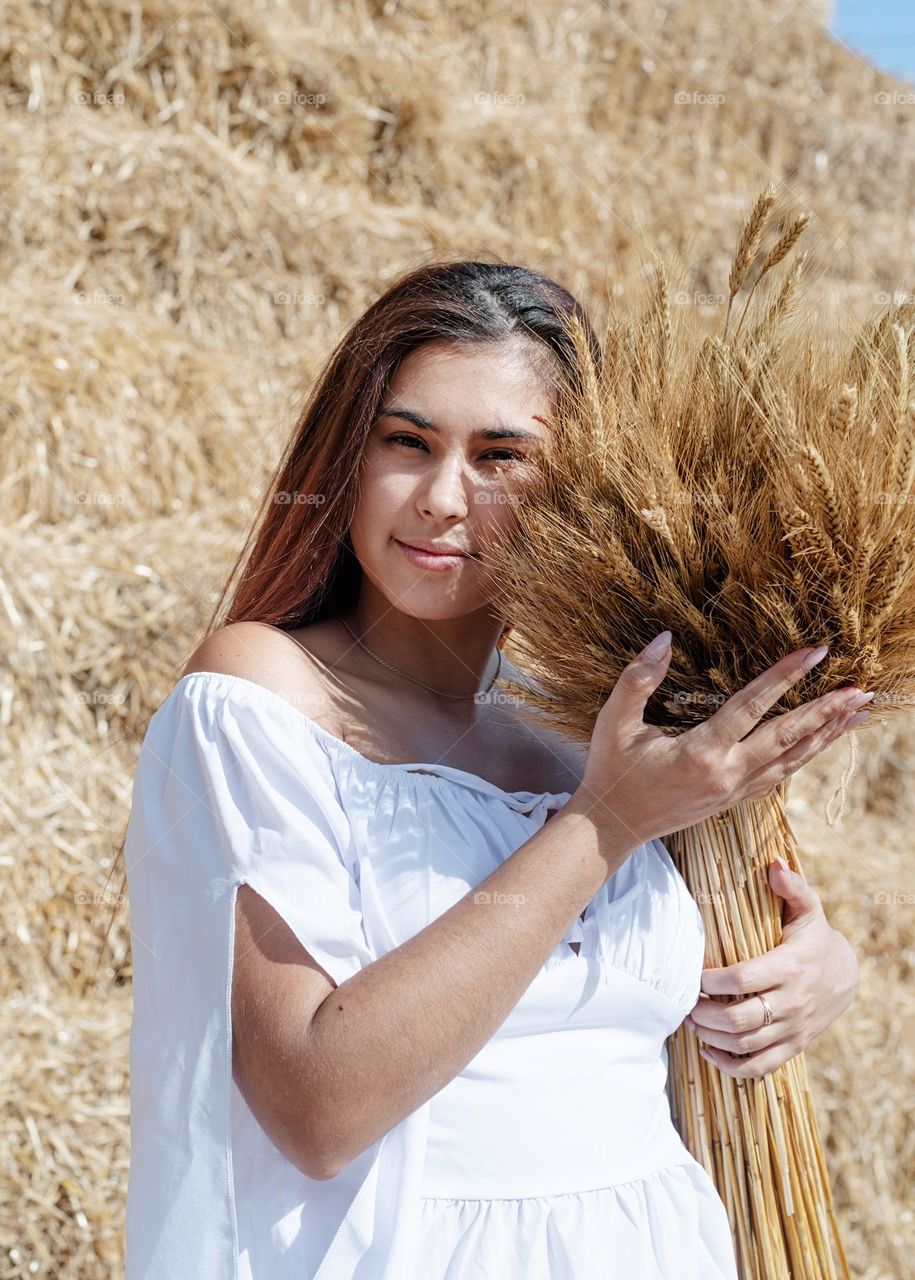 happy woman in countryside with wheat