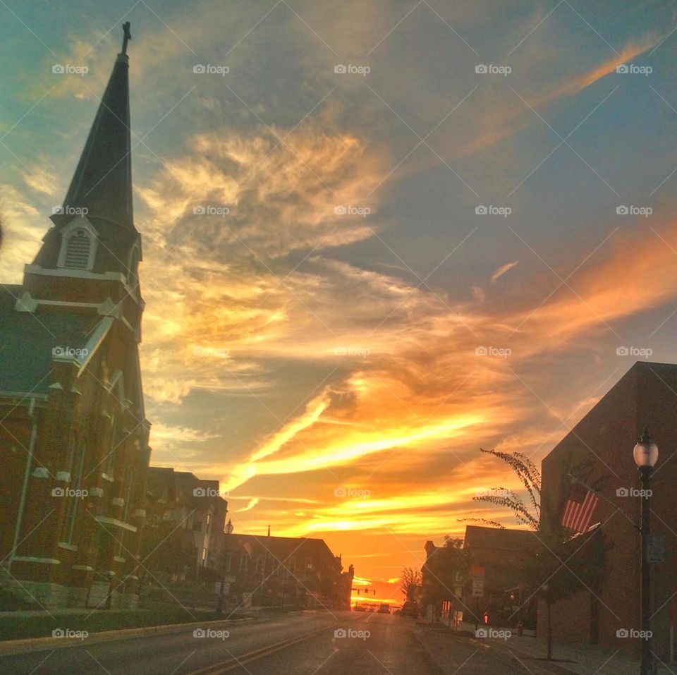 Church and town view driving into the fiery sunset