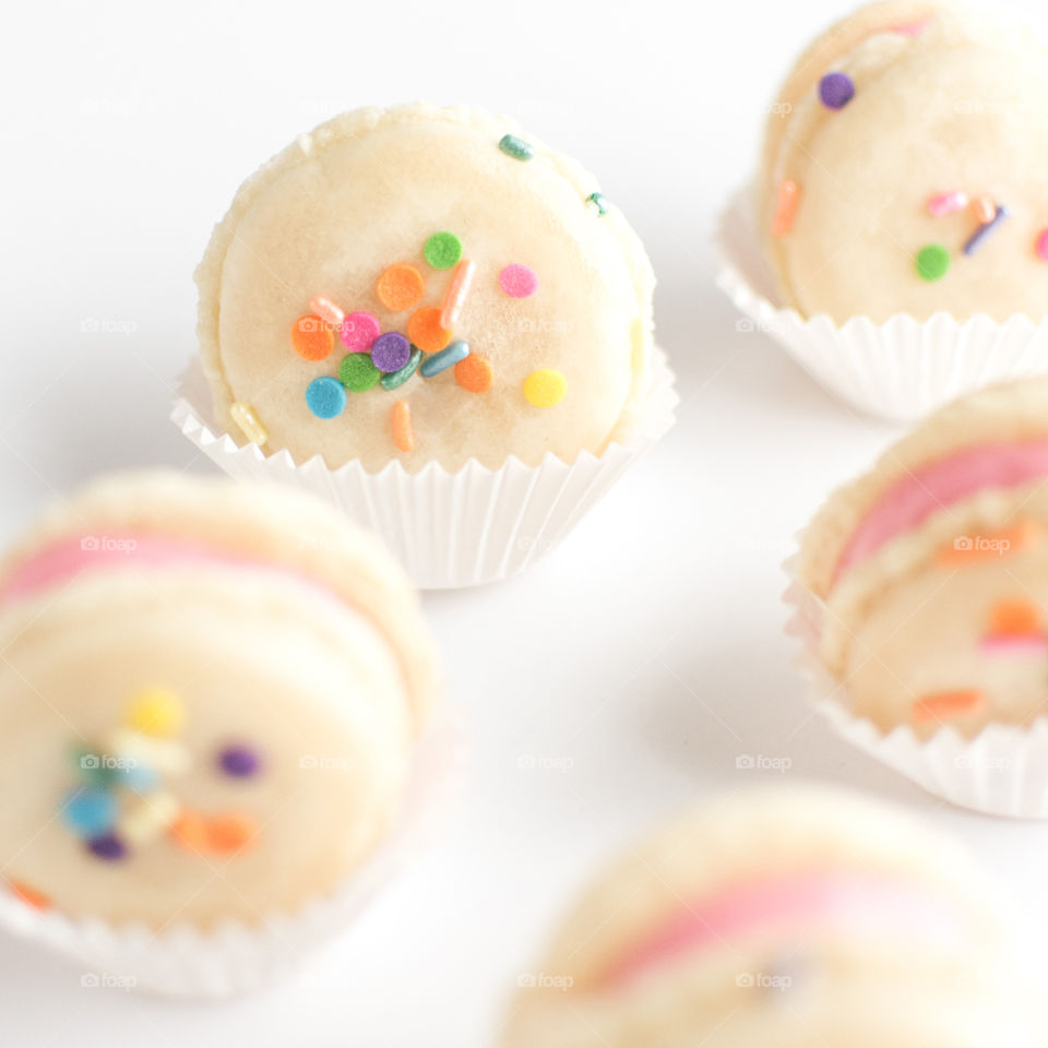 Funfetti french macarons on white background