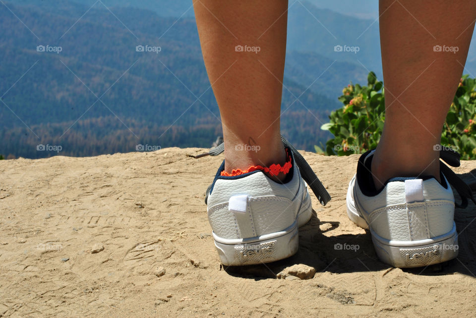 white sneaker shoes in hiking view