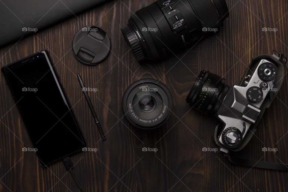 Top view of photography accessories.  Dark mood style