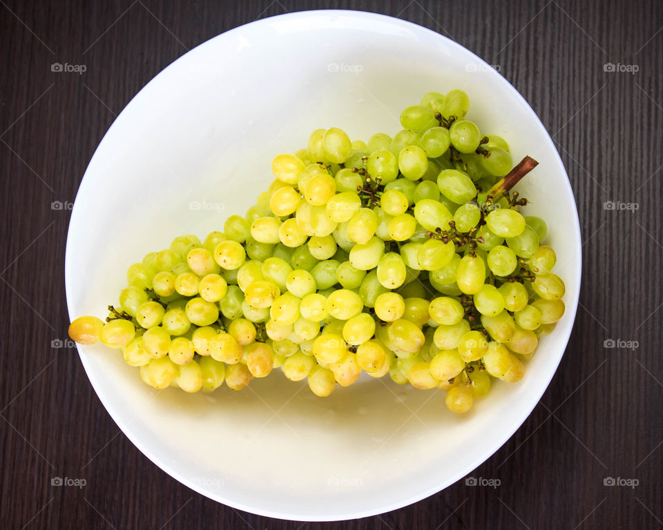 branch of grapes on a white plate